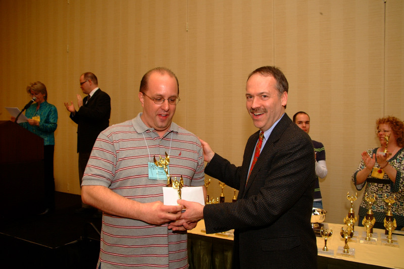 Doug Peterson receiving trophies from Will Shortz