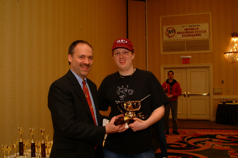 Will Shortz giving 1st prize trophy to Tyler Hinman